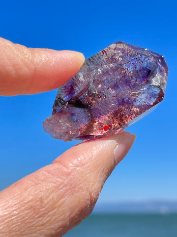 super seven amethyst on a sky blue background